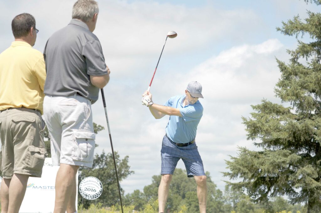 Photo of golfer teeing off.